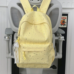Détail du sac à dos en toile à motifs d'étoiles avec un nœud décoratif en dentelle