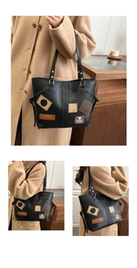 Close-up of black leather tote bag with vintage patches and spacious interior design