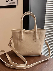 Bolso cubo beige minimalista con asa superior y herrajes dorados para el día a día
