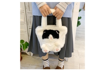 Close-up of white plush cat bucket bag featuring cat paw embroidery and lace collar