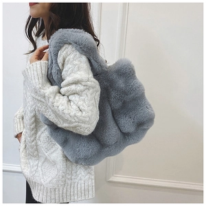 Detail of gray faux fur tote bag showing plush texture and spacious winter style