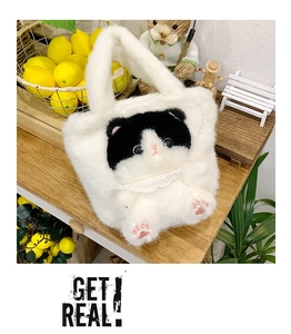 Detail of white plush cat bucket bag with cute 3D ears and pink paw embroidery