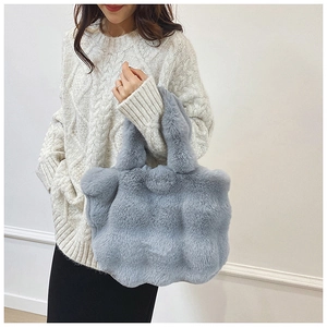 Detail of plush misty blue faux fur tote bag with soft quilted texture for women