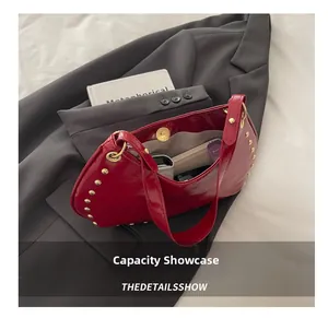 Internal capacity of the red punk shoulder bag showing space for phone and makeup