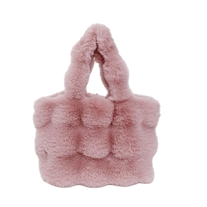 Pink plush faux fur tote bag with stylish bubble quilted texture and soft top handle