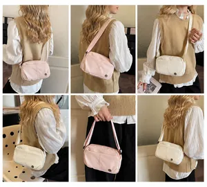 Model wearing the pink and beige crossbody bags with adjustable wide shoulder straps