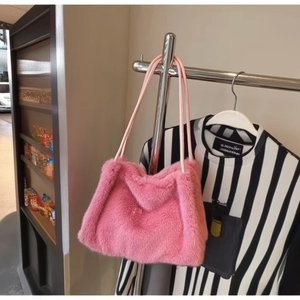 Dettaglio borsa a spalla in ecopelliccia rosa con sottili tracolle in pelle per l'inverno