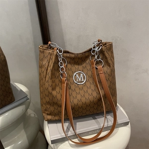 Large brown tote bag with M-letter print and silver chain strap for commuting