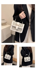 Detailed view of monogrammed crossbody bag featuring faux leather trim and gold buckle