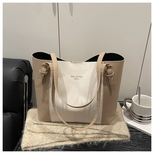 Detail of a beige contrast tote bag featuring the Tidal Dryness Bags print and buckle accents