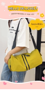 Detail of yellow nylon yoga travel bag with decorative vertical black zippers and strap