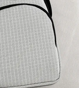 Detail of light gray mesh fabric texture and black zipper on a crossbody phone bag