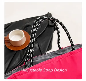 Detail of adjustable woven rope strap on a large rose pink nylon tote handbag