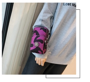 Detail of purple camo sports armband bag with multi-layer zippers and SPORT logo