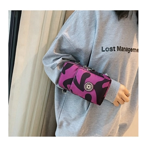 Detail of nylon crossbody phone bag with purple camo print and sport zipper closure