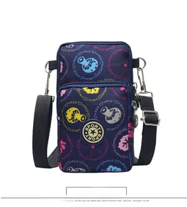 Vertical blue nylon crossbody phone bag with floral patterns and adjustable strap