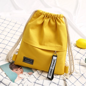 Yellow canvas drawstring backpack with fashion zipper tape on a blue plaid background