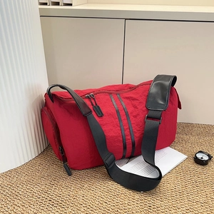 Waterproof red travel bag for yoga and fitness with adjustable black shoulder strap
