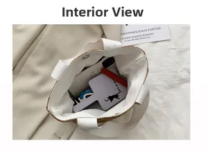 Interior view of white straw tote bag showing magnetic buckle and spacious capacity