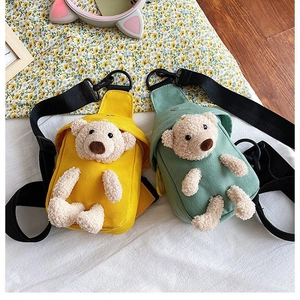Detail of yellow and mint green canvas crossbody bags featuring cute 3D plush bears