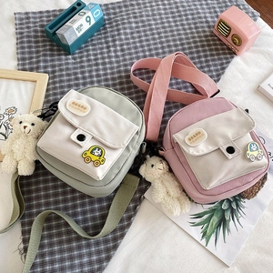 Cute Japanese style canvas crossbody bags in green and pink with teddy bear charm