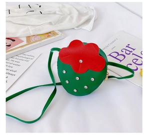 Detailed view of green strawberry girl purse with red flower and silver studs