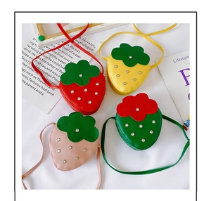 Detail shot of strawberry-shaped kids' bags in red, yellow, pink, and green colors