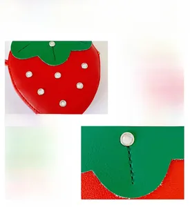 Close-up of strawberry purse featuring red leather, rhinestone leaves, and neat stitching