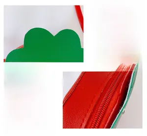 Detail of red strawberry children bag showing leather texture and smooth zipper