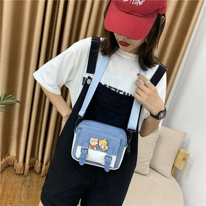Vue détaillée d'un sac à bandoulière en toile bleu et blanc avec motifs d'oursons mignons