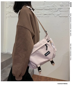 Detail of high-capacity messenger bag featuring buckle closure and urban techwear design