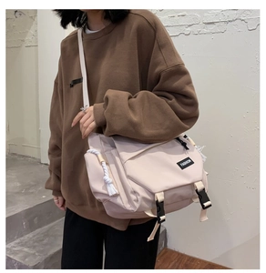 Beige large capacity messenger bag with adjustable buckles and functional straps