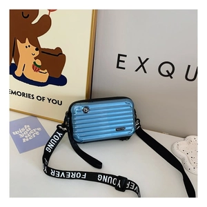 Blue mini suitcase crossbody bag with Forever Young strap and hard shell design