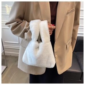 Close-up of white plush faux fur handbag texture with elegant soft fuzzy material detail
