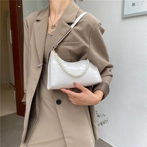 White faux crocodile leather baguette bag with elegant pearl strap and shoulder strap