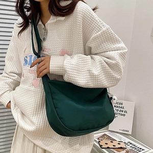 Minimalist large nylon crescent crossbody bag in dark green for daily commuting style