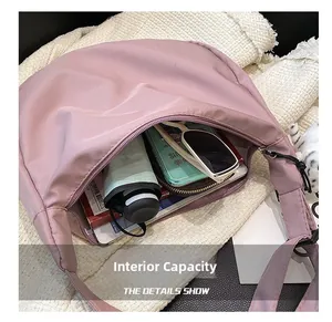 Top view of large nylon crescent bag showing spacious interior and daily essentials