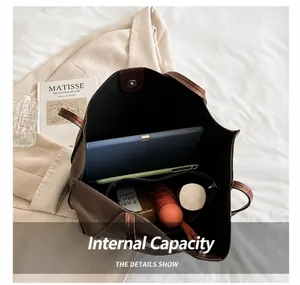 Interior view of brown leather tote bag showing large capacity for tablet and umbrella