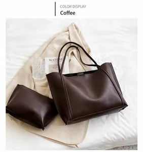 Detail of coffee brown tote bag set with detachable inner pouch on white bedding