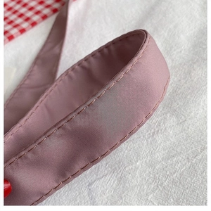 Detailed close-up of durable nylon shoulder strap with reinforced stitching on a hobo bag