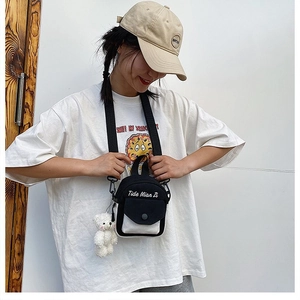 Mini canvas crossbody bag in black and white with a cute plush bear charm detail