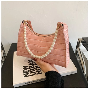 Pink faux crocodile underarm bag with large pearl handle and gold zipper detail