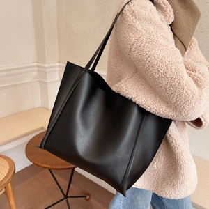 Classic black leather tote bag for women showing a large capacity and minimalist shoulder style