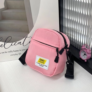 Dettaglio della mini borsa a tracolla in nylon rosa con tasca anteriore e cinturino