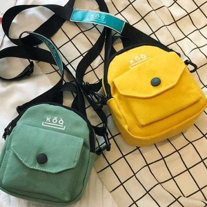 Mini canvas crossbody bags in mint green and bright yellow with adjustable straps