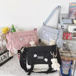 Retro canvas messenger bag in black, blue and pink with cute bear charm and shoulder strap
