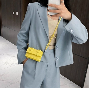 Bright yellow mini crossbody bag with double buckle strap and matching chain detail