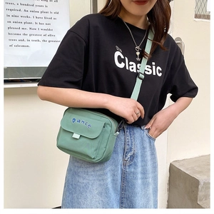 Minimalist mint green canvas crossbody bag with blue Dance embroidery and adjustable strap
