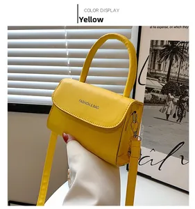 Detail of yellow mini crossbody bag with Fashion & Bag logo and handle