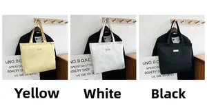 Detailed comparison of three colors of minimalist canvas tote bags hanging on hooks